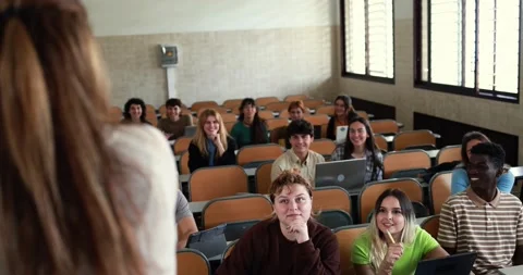 Mature teacher working with students inside classroom at school university Stock Footage 203723385