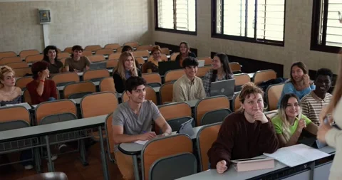 Mature teacher working with students inside classroom at school university Stock Footage 203723420