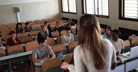 Mature teacher working with students inside classroom at school university Stock Footage 203723626