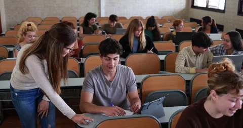 Mature teacher working with students inside classroom at school university Stock Footage 203724485