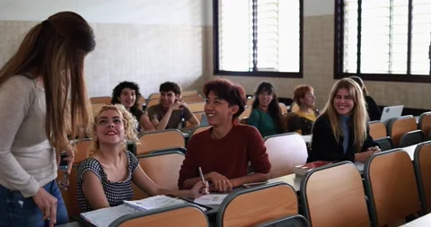Mature teacher working with students inside classroom at school university Stock Footage 203726137