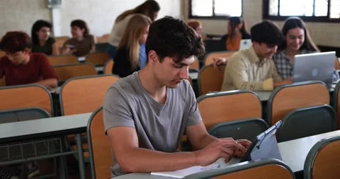 Mature teacher working with students inside classroom at school university Stock Footage 203726231