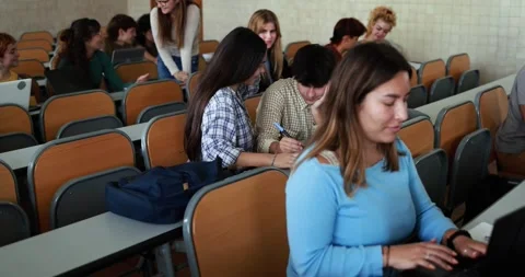 Mature teacher working with students inside classroom at school university Stock Footage 203726678