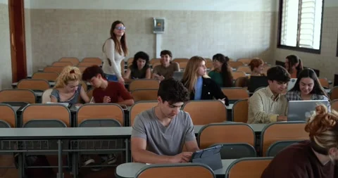 Mature teacher working with students inside classroom at school university Stock Footage 203727046