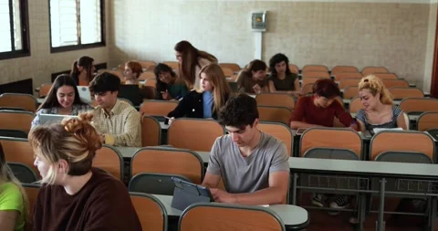 Mature teacher working with students inside classroom at school university Stock Footage 203727259