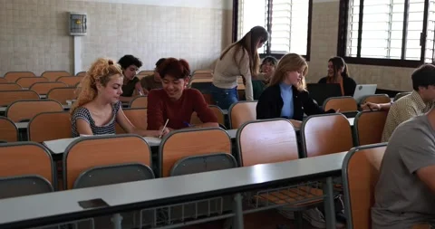 Mature teacher working with students inside classroom at school university Stock Footage 203727414