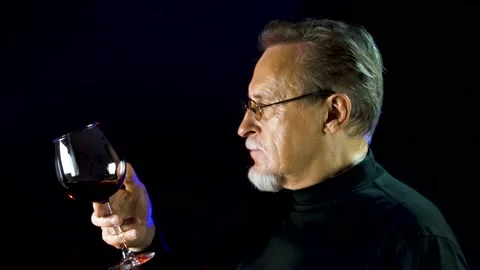 Mature winemaker checking color, quality, and sediments of wine. Stock Footage 136958073