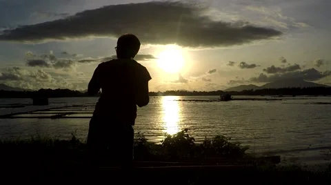 Mature woman Dance Exercise at lake shore. silhouettes Stock Footage