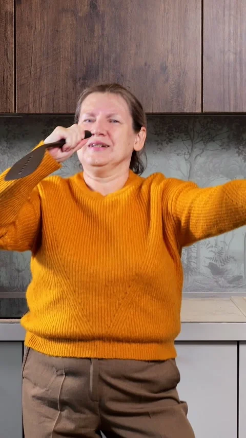 Mature Woman Dancing At Home Expresses Pure Happiness While Singing Into Black 스톡 동영상 346989853