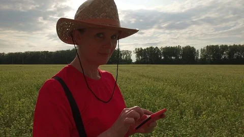 Mature woman Farmer on sends message from phone on nature Stock Footage