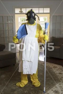 Mature woman in Haz Mat suit with broom and dust pan Stock Photos