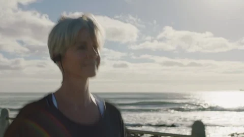 Mature woman running exercising enjoying beautiful seaside morning healthy Stock Footage 92714479