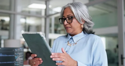 Mature woman, software developer and research with tablet in office for Stock Footage 329401947