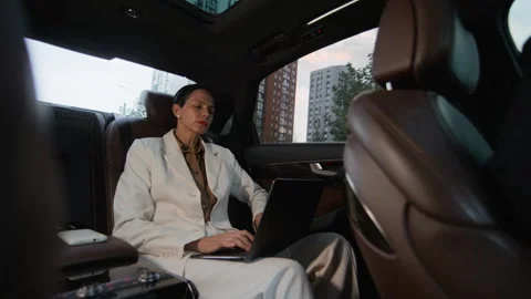 Mature Woman Using Gadgets while Commuting to Work by Business Class Car Stock Footage 321451813