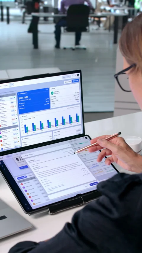 Mature Woman Working On Payroll Data Using Laptop Stock Footage 343892242