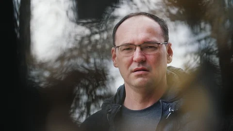 Matured handsome man looking around on the street in slow motion 動画素材 105338118