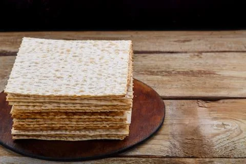 Matzo stack on a round stand on a wooden table. copy space. Stock Photos