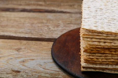 Matzo stack on a round stand on a wooden table. copy space. Stock Photos