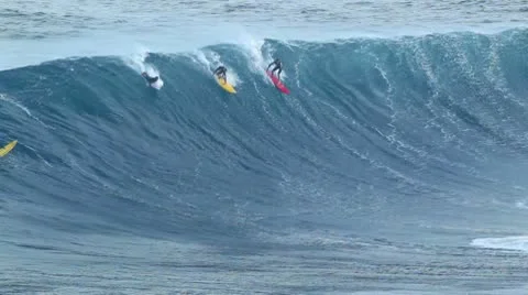 Maui, hi - march 13: professional surfers ride a giant wave at the legendary Stock Footage