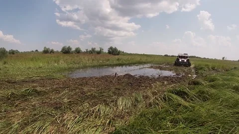 Maverick X3 driving through the puddle in the meadow Stock Footage 159352988