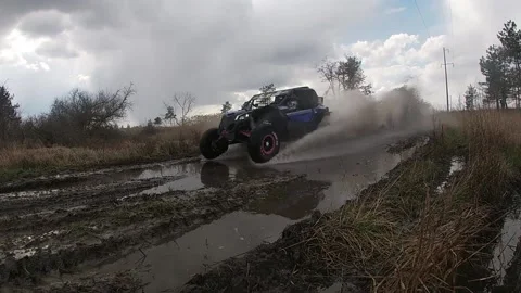 Maverick X3 flies through a puddle Stock Footage 156655134