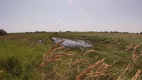 Maverick X3 passes big puddle on hight speed with bright splashing water Stock Footage 159353084