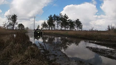 Maverick X3 rides through the puddle with big sprays Stock Footage 156655155