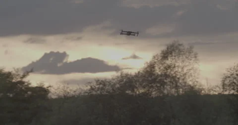 Mavic flys sideways to the right, sunset and forest in the background Stock Footage 150755223