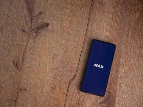 Max app launch screen with logo on the display of a black mobile smartphone o Stock Photos