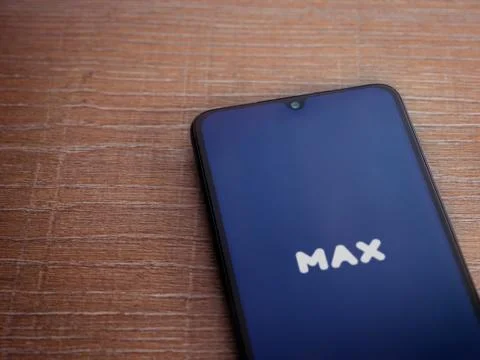 Max app launch screen with logo on the display of a black mobile smartphone o Stock Photos