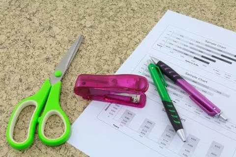Max stapler scissors paper chart and pens Stock Photos
