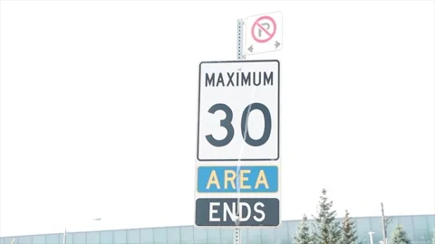 Maximum 30 area ends no parking signs on metal post in summer, white blue black Stock Footage 251369232