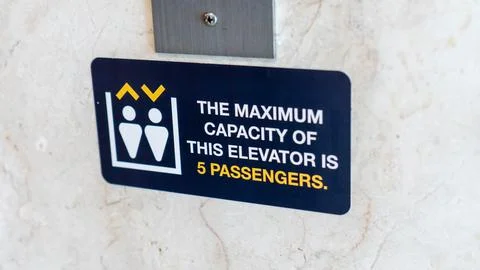 The Maximum Capasity of This Elevator Is 5 Passengers. Elevator Advisory Stock Photos