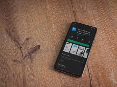 Maxthon Browser app play store page on the display of a black mobile smartpho Stock Photos