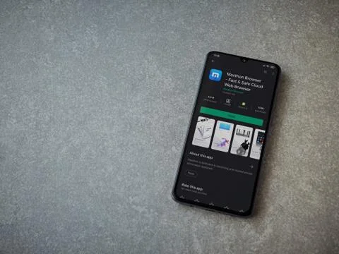 Maxthon Browser app play store page on the display of a black mobile smartpho Stock Photos