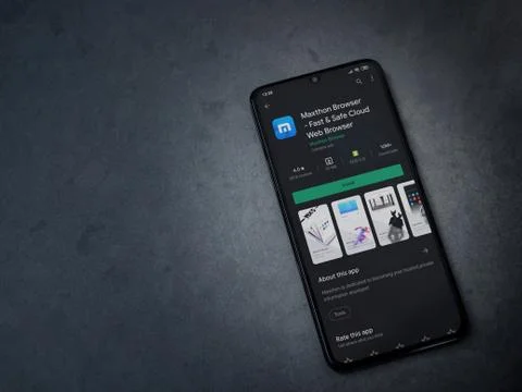 Maxthon Browser app play store page on the display of a black mobile smartpho Stock Photos