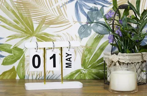 May 1 Calendar Display with Spring Floral Wallpaper, Potted Plant and Scented Ca Stock Photos