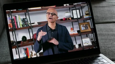 MAY 10, 2023: Microsoft CEO Satya Nadella on AI, Watching the Video on TIME Stock Footage 244136362