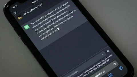 MAY 17, 2023: Asking ChatGPT if AI Will Replace Human Work, iPhone Screen Close Stock Footage 241413682