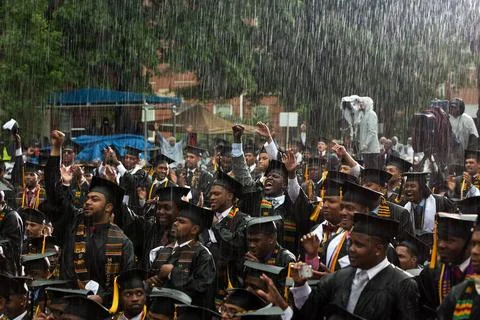 May 19, 2013 Graduates react in the pouring rain as the President delivere... Stock Photos