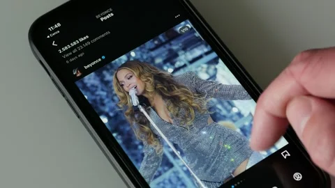 MAY 29, 2023: Watching Beyonce Instagram Account on an iPhone Stock Footage 242429900