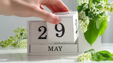 May 29. female hand sets the date on the calendar. Spring season. White cubic ca Stock Footage 194529030