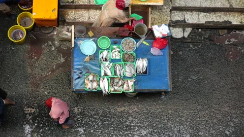 May 4, 2024, Jakarta-High angle view of fish seller at the fish market. Stock Footage 274688780