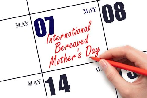 May 7. Hand writing text International Bereaved Mother's Day on calendar da.. Stock Photos