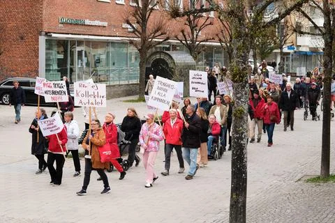 May Day demonstrators marching. Protesters demand social reform and workers Stock Photos