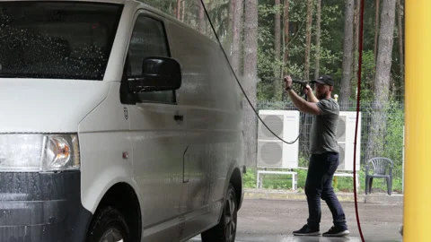 May, Lithuania 2021. A man washes his white car, wash a bus at a car wash, Stock Footage 154399238
