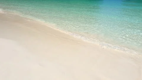 Maya Bay fine sand at beach, turquoise waves of tropical sea. Close up video. Stock Footage 203882822