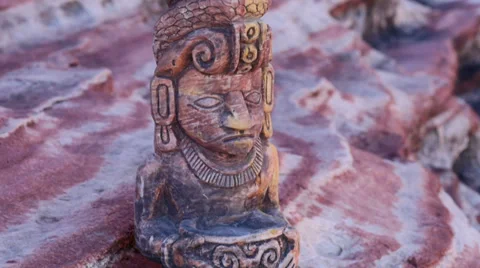 Mayan Statue on Rock Ledge Close Up Tilt and Pan Stock Footage 35121421