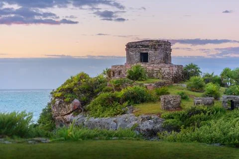 Mayan temple at sunset on tulum cliffs overlooking caribbean sea Stock Photos