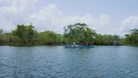 Mayan's Canoeing Down Belize River Stabilized Footage 4K Stock Footage 94471536